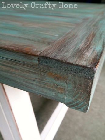 a close up of a wooden table with white legs and wood grain on it's surface