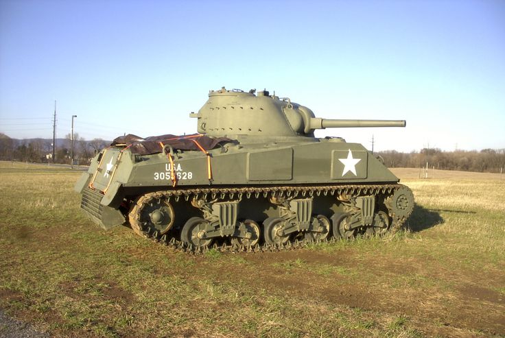 an army tank sitting in the middle of a field