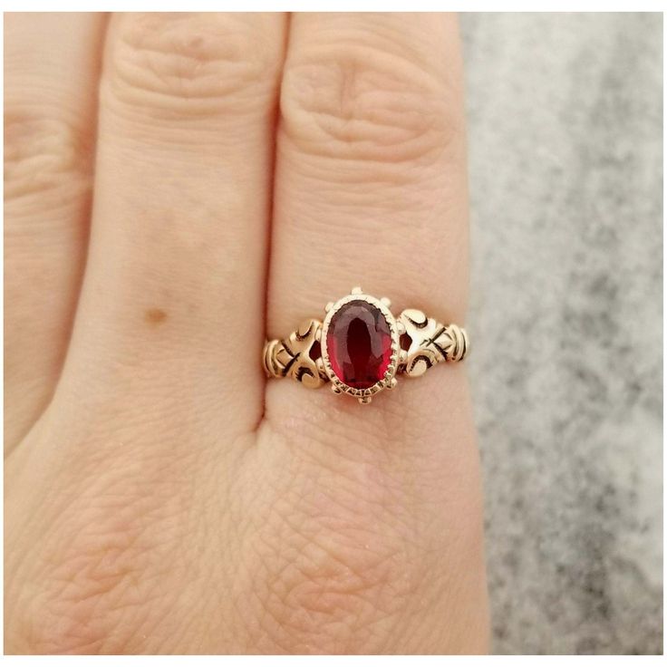 This is an oval garnet gemstone bezel set in a stunning antique rose gold band. The band has a unique shoulder design. The ring is a size US 7 The front of the ring measures  3/8 inch (10.3mm) tall 1/4 inch (8mm) wide It doesn't have a gold mark but acid tests as being made from 10k gold. The ring is in good antique condition. It does show some wear overall and the band appears to have been resized. Please inspect photos closely before purchasing. This item will be shipped fully insured with signature conformation in the United States. Just send me a message if you have any questions. Oval 14k Rose Gold Fine Jewelry, Oval Ruby Ring With Rose Cut Diamonds, Antique Oval Ruby Promise Ring, Classic Oval Rose Gold Birthstone Ring, Oval Rose Gold Ruby Ring For Anniversary, Oval Rose Gold Ruby Ring With Rose Cut Diamonds, Rose Gold Ruby Ring Oval, Oval Birthstone Ring With Rose Cut Diamonds, Classic Oval Rose Gold Ruby Ring