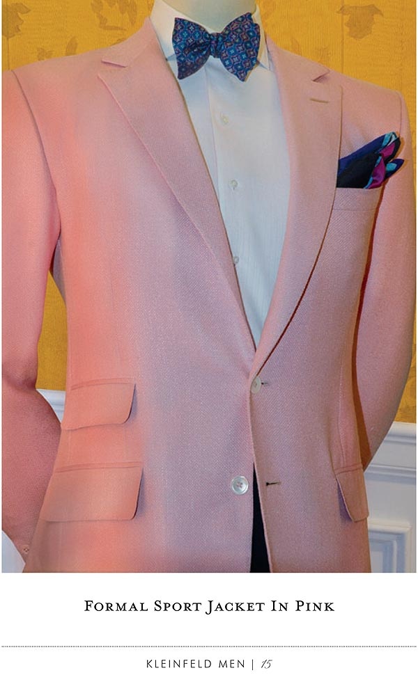 a mannequin wearing a pink suit with a blue bow tie and white shirt