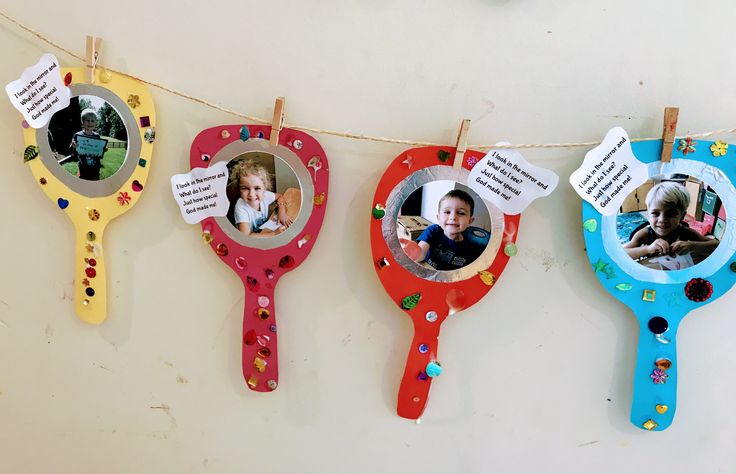 three photo frames hanging from clothes pins on a line with clothes pins attached to them