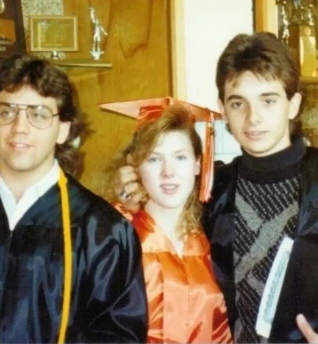 two men and a woman in graduation gowns