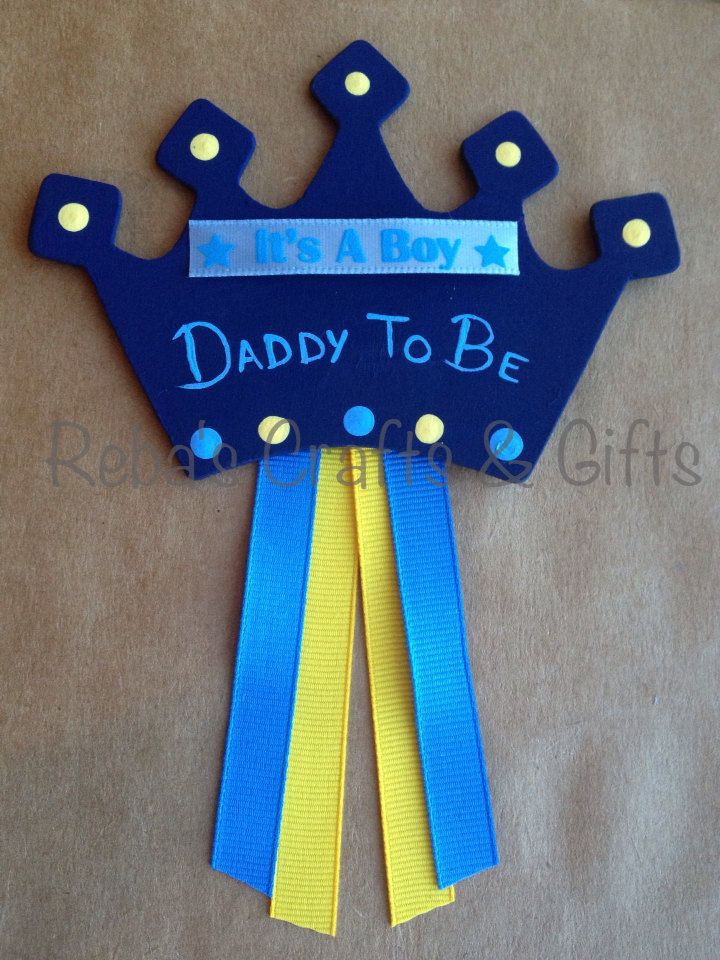 a blue and yellow ribbon with a crown on it that says, daddy to be