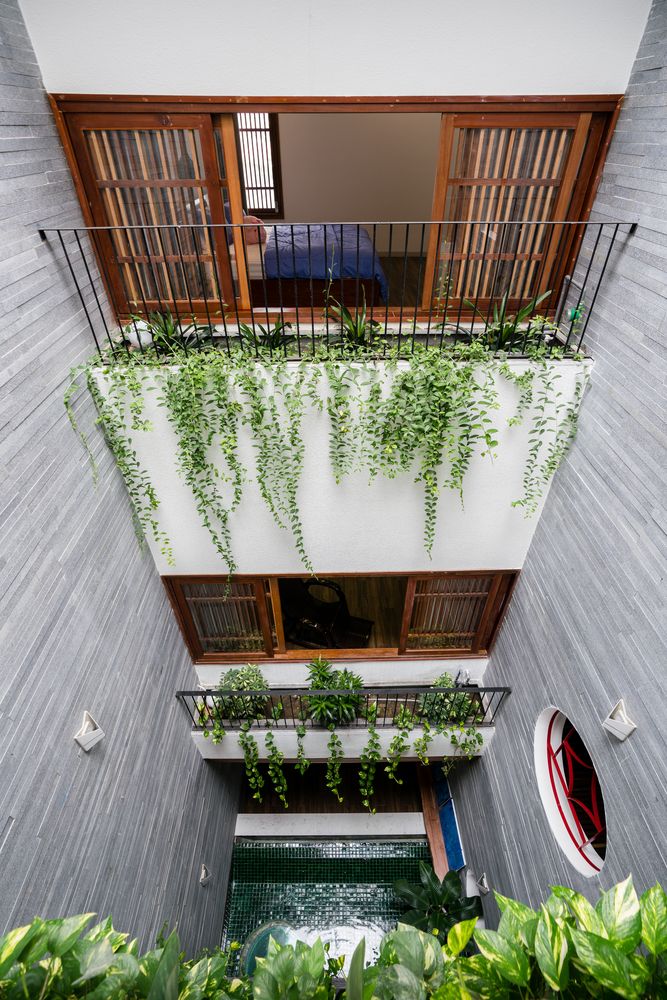 an apartment building with plants growing on the balconies