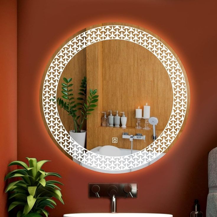 a bathroom with a sink, mirror and potted plant