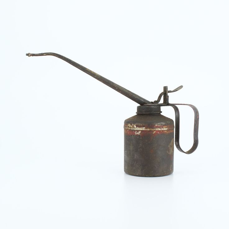 an old fashioned gas can with a long handle