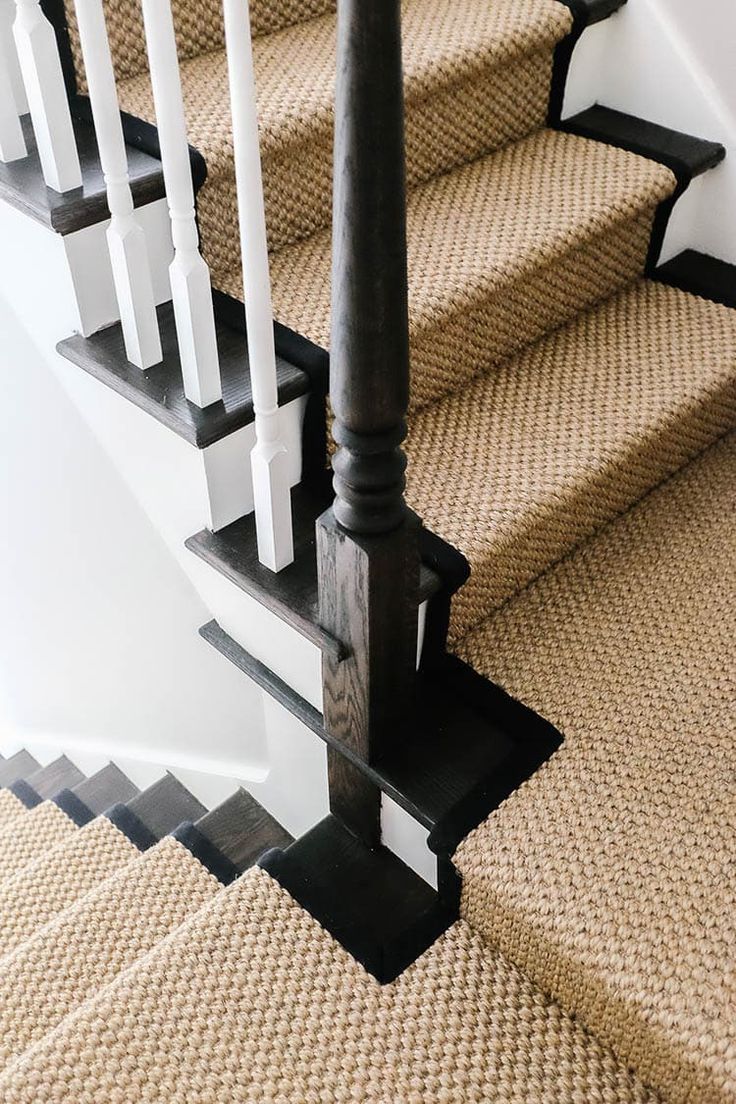 an image of a staircase going up to the second floor with carpeting on it