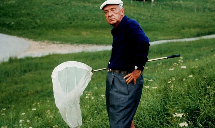 an old man holding a net in the grass