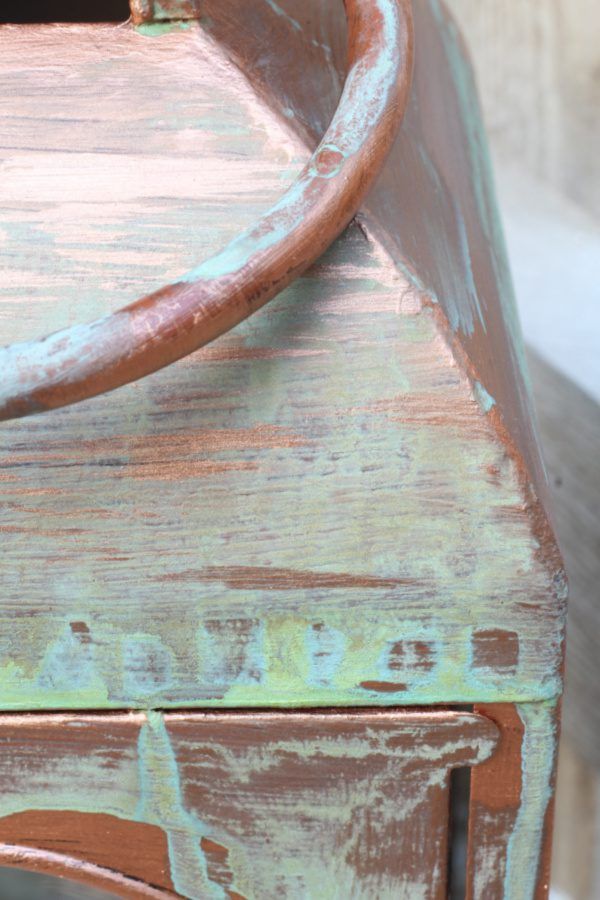 an old wooden bench with rusted paint on it's sides and the seat up