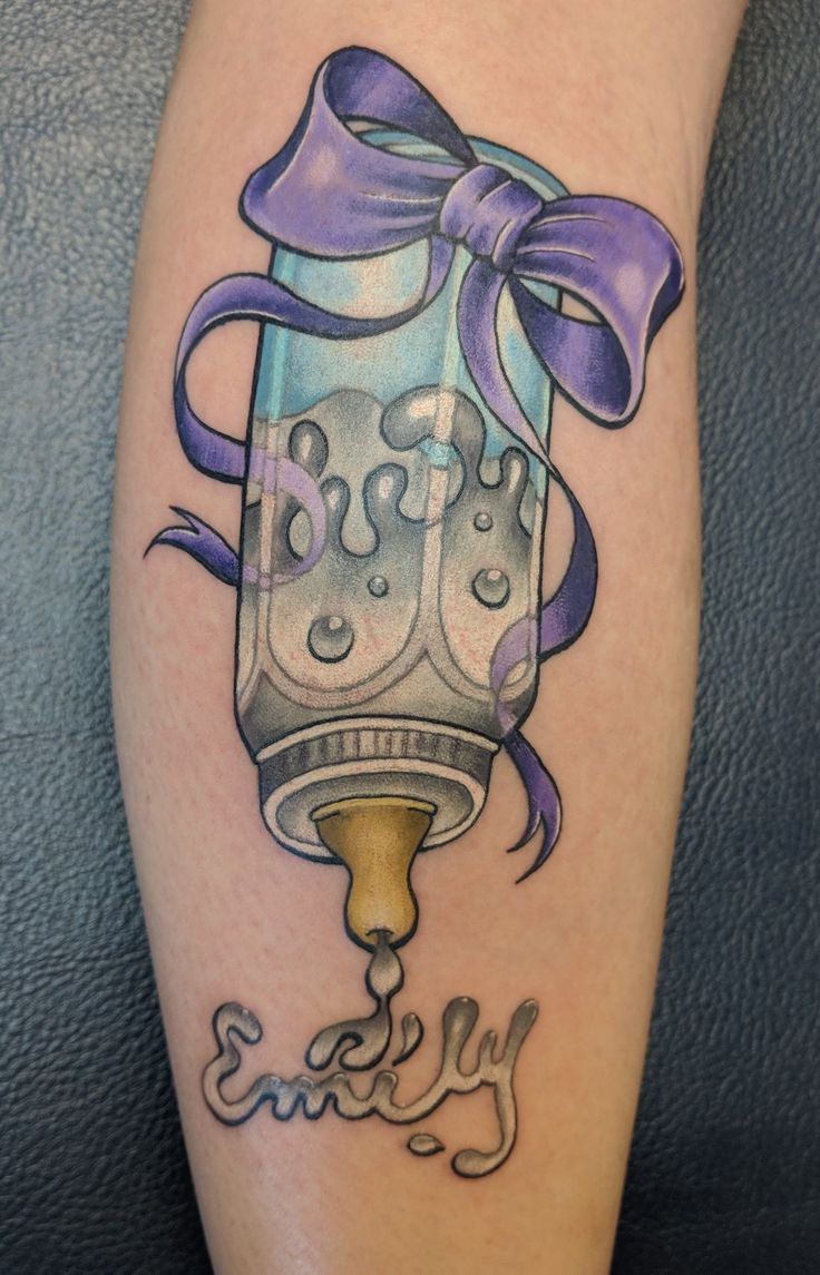 a tattoo on the leg of a person with a purple ribbon around it and a lantern