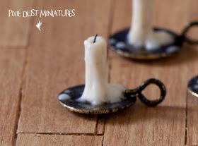 three miniature candles sitting on top of a wooden table