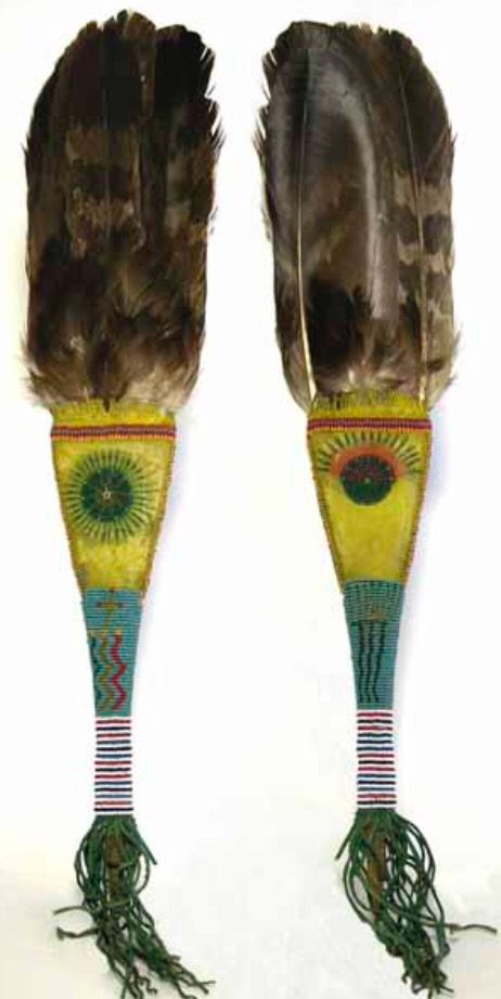 two large feathers with designs on them