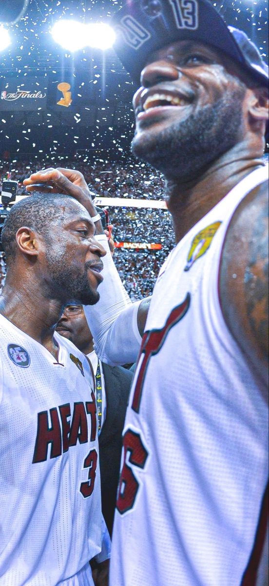 two men standing next to each other at a basketball game