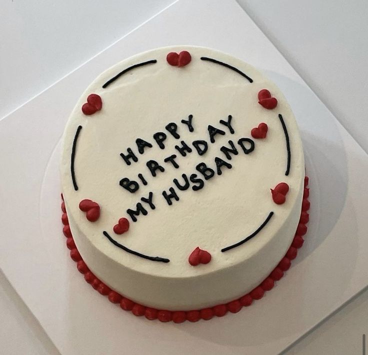 a birthday cake with the words happy birthday my husband written in black and red on it