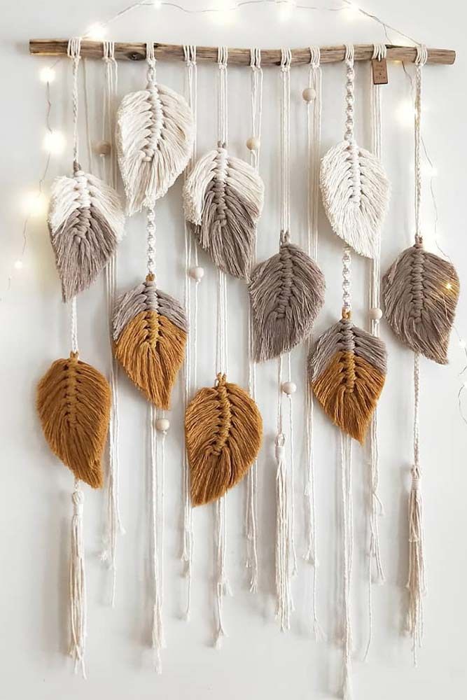 a wall hanging with leaves and string lights