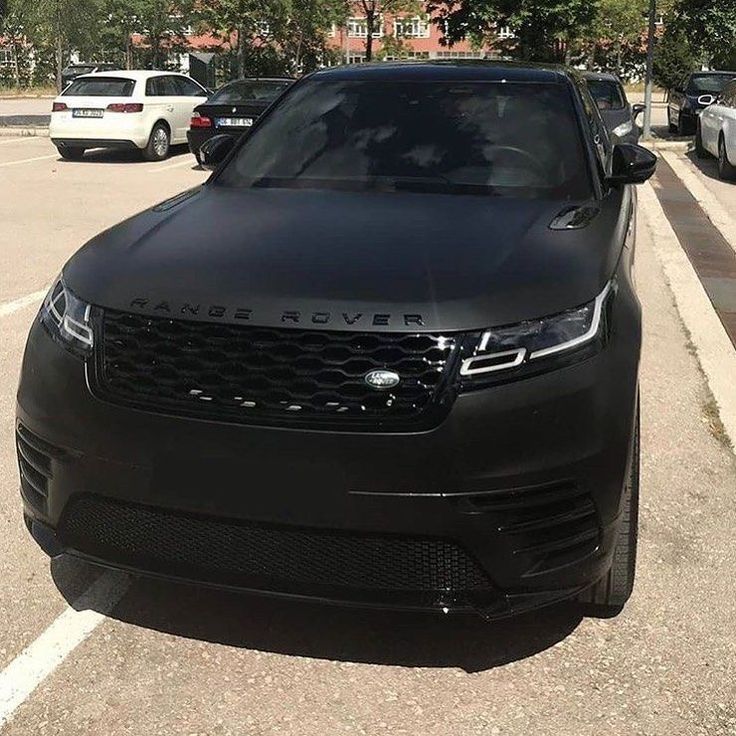 a black range rover parked in a parking lot