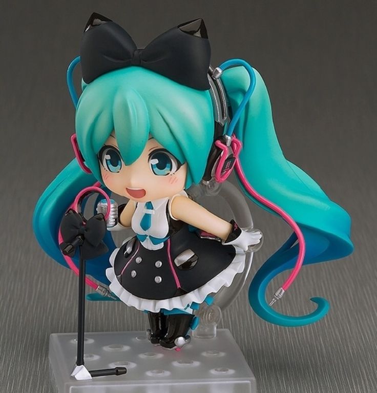 a doll with blue hair holding a microphone and wearing a black bow, white shirt and polka dot skirt