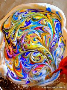 a colorful swirl cake sitting on top of a pan