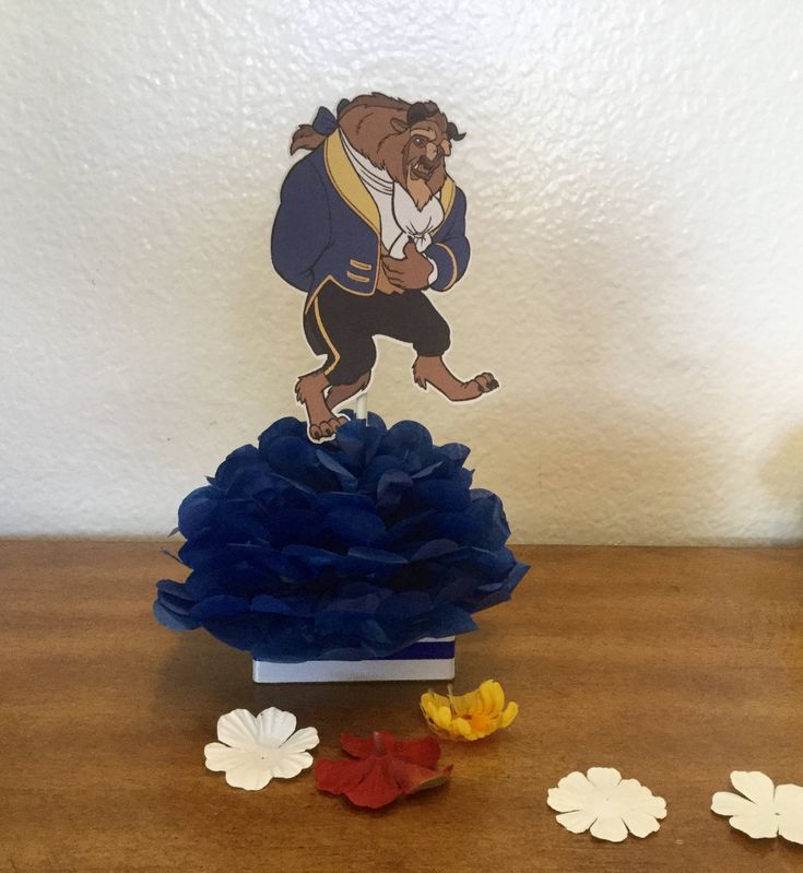 there is a paper cutout of a bear on top of a blue flower pot