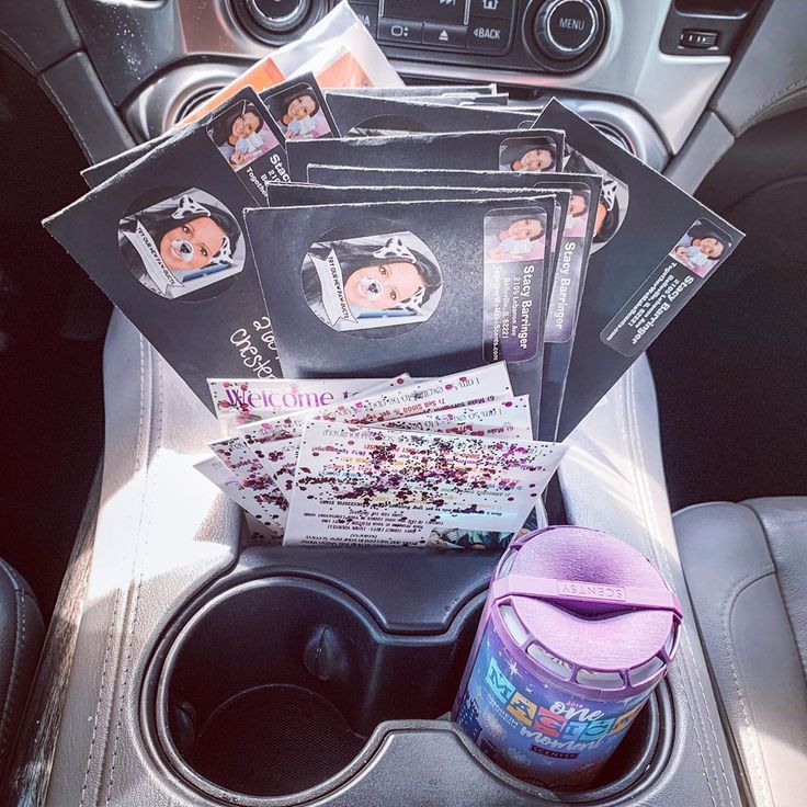 the inside of a car with various items in it and pictures on the dash board