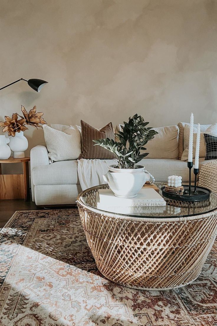 a living room with a couch, coffee table and rug on top of the floor