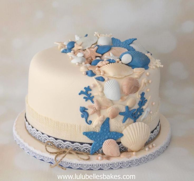 there is a cake decorated with seashells and starfish