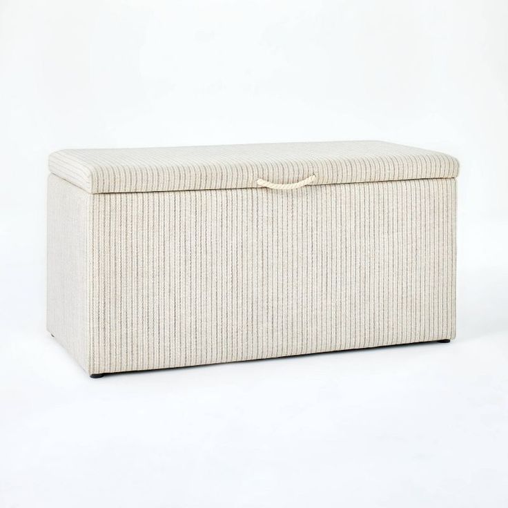 an upholstered storage box is shown on a white background