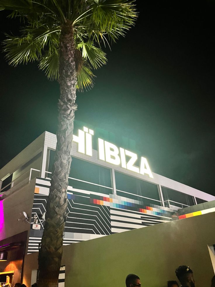 people are standing in front of a building with a sign that says it ibiza