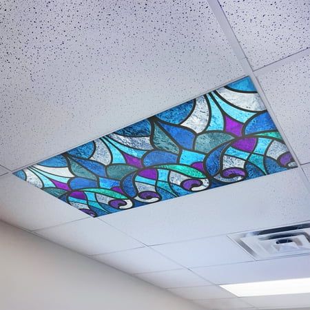 the ceiling in an office building is decorated with blue and purple stained glass designs on it