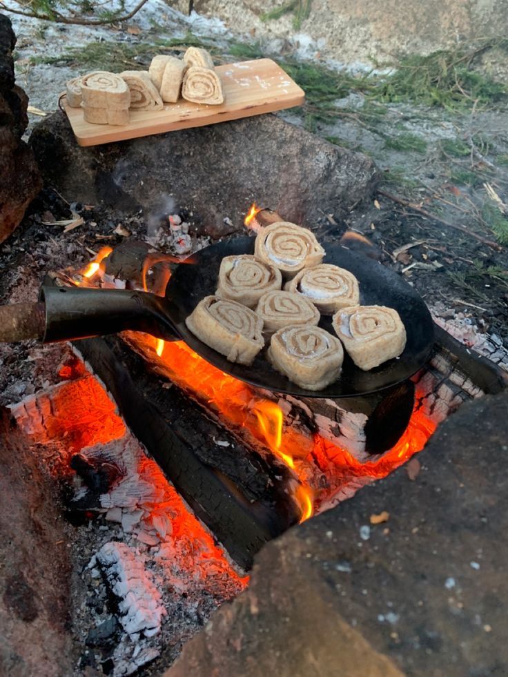 some food is cooking over an open fire