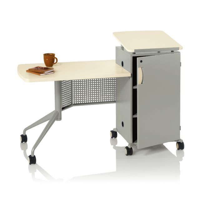 an office desk with a cabinet on wheels and a coffee cup sitting on the table