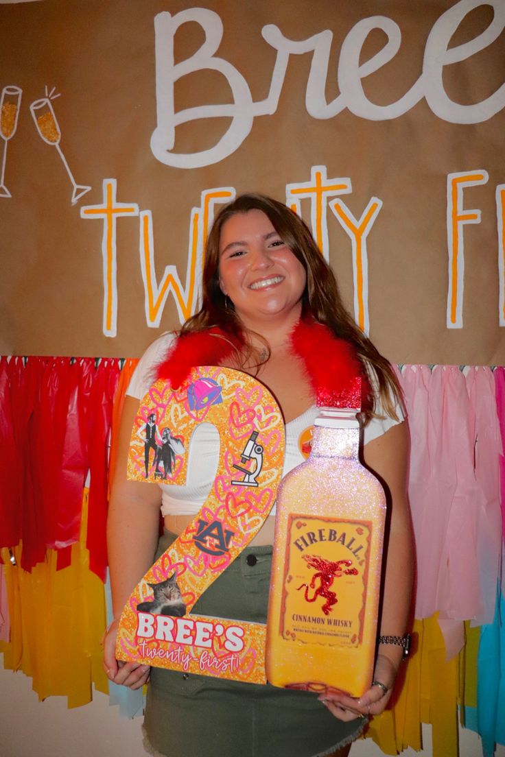 a woman holding two bottles of booze in front of a sign that says beer twenty five