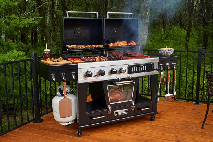 an outdoor bbq grill on a deck in the woods