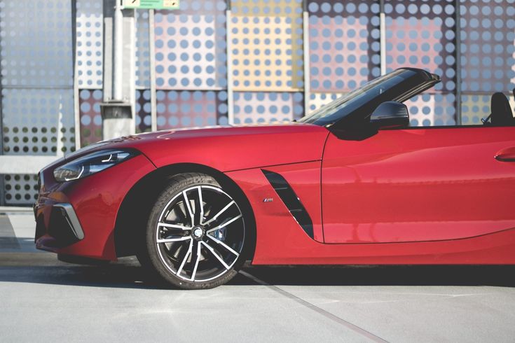 a red sports car parked in front of a building