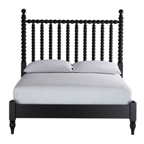 a black bed frame with white sheets and pillows on top of it, in front of a white background