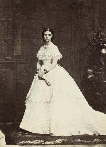 an old black and white photo of a woman in a dress