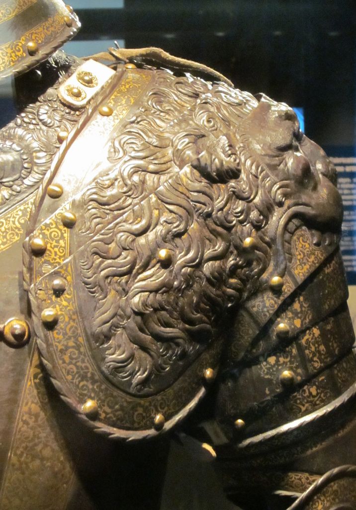 a close up of a helmet and armor on display