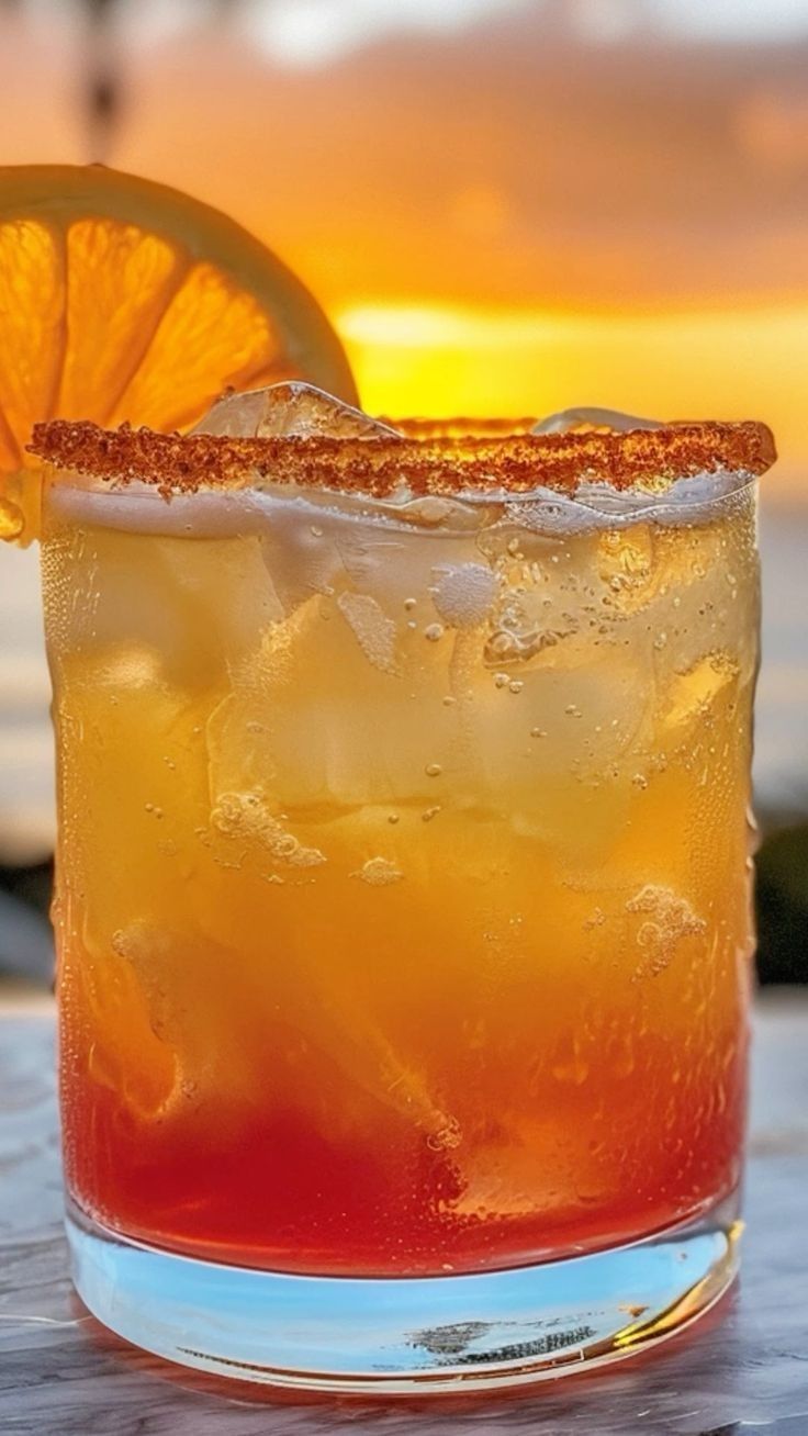 a close up of a drink on a table with an orange slice in it's garnish