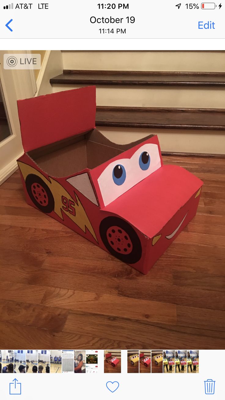 the cardboard box is made to look like a race car with eyes and nose on it