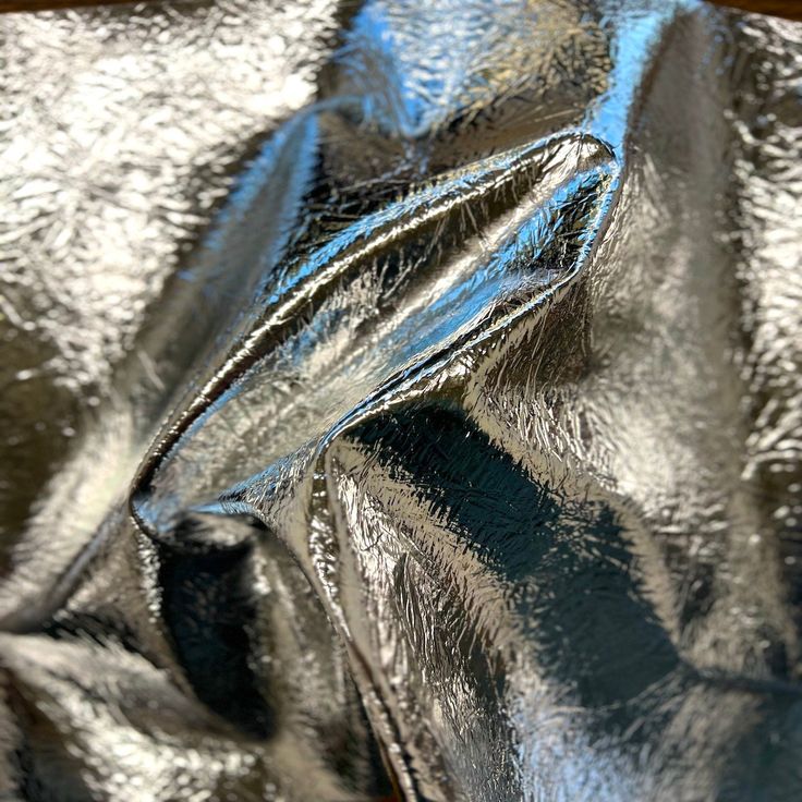 a close up view of shiny silver material