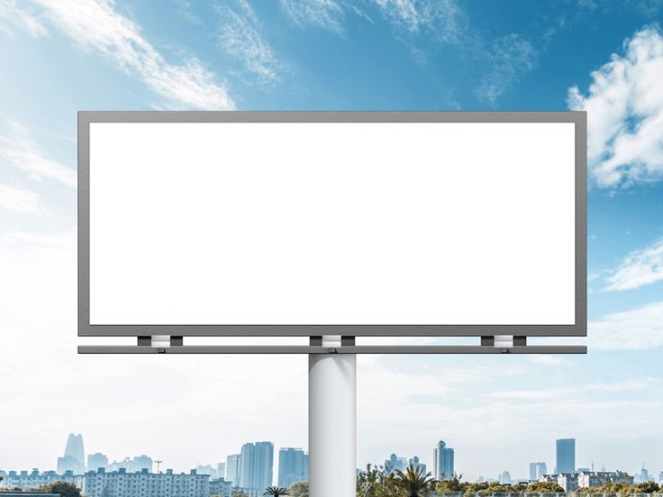 an empty billboard in front of a cityscape with blue sky and white clouds