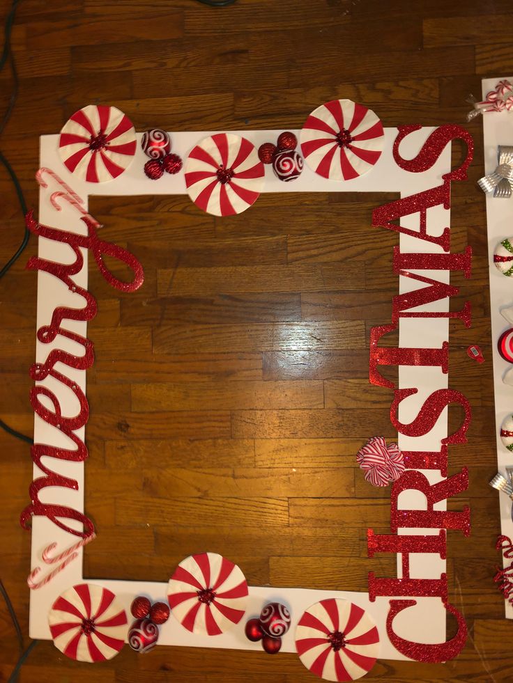 a photo frame decorated with candy canes and the words happy birthday on it, sitting on a wooden floor