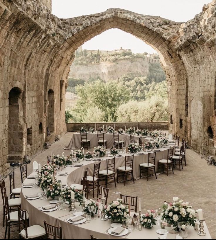 an outdoor dining area with tables and chairs set up for a formal function at the castle