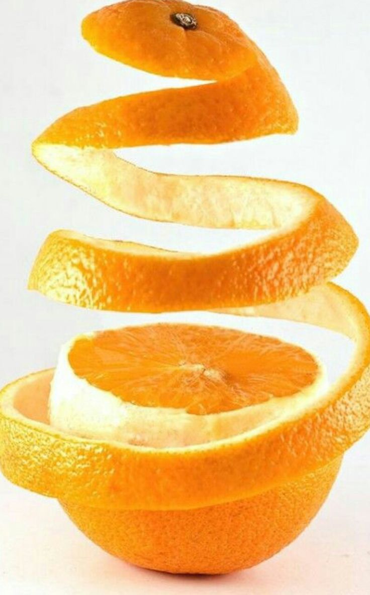 an orange sliced in half with the peels still attached to it's core