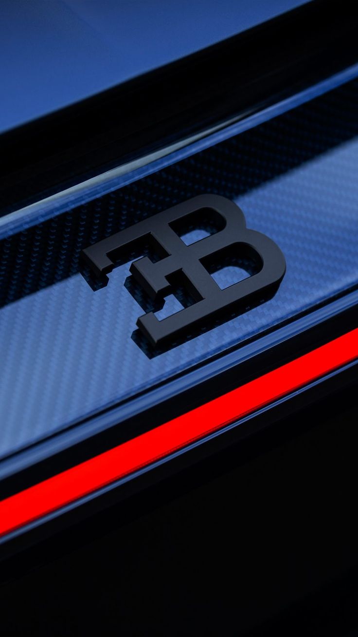 the emblem on the back of a black and blue sports car with red stripeing