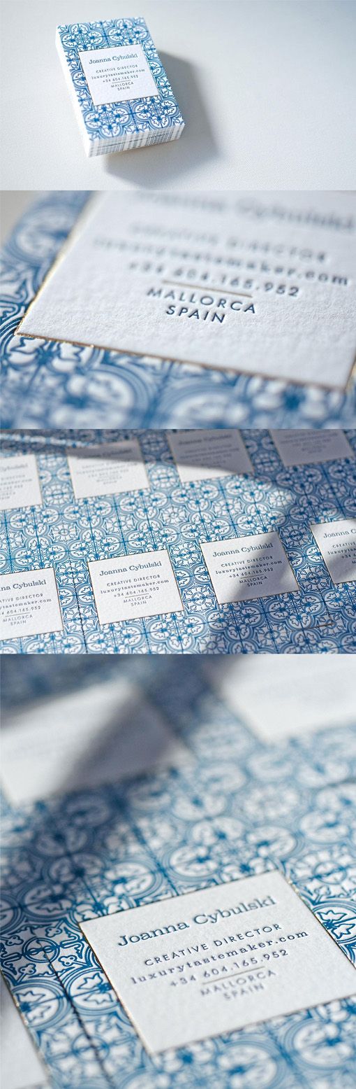 the blue and white business card is folded in two different sections, with an intricate pattern on