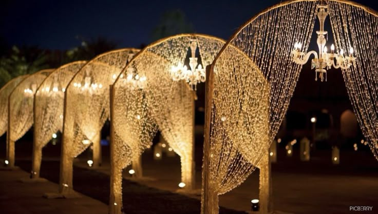 a row of lighted archways with lights hanging from them