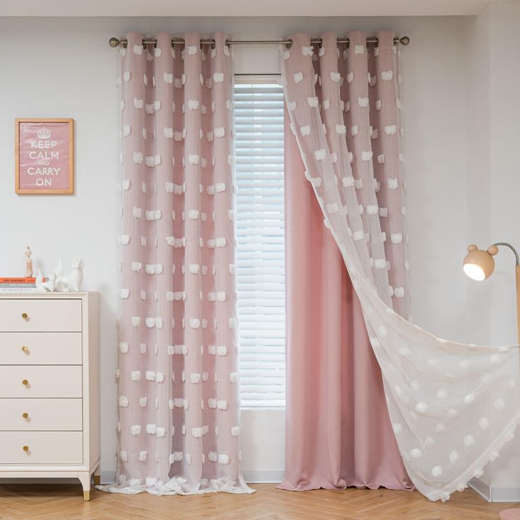 a pink and white bedroom with polka dots on the curtains, bedding and dresser