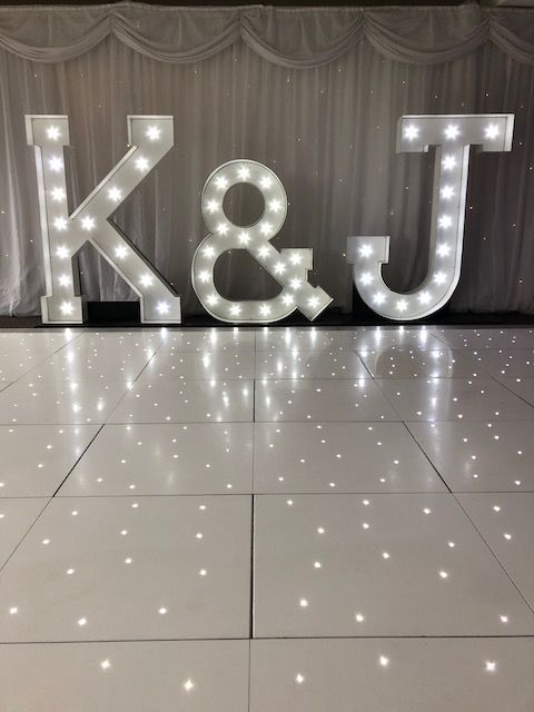 the letters k and j are lit up on the dance floor