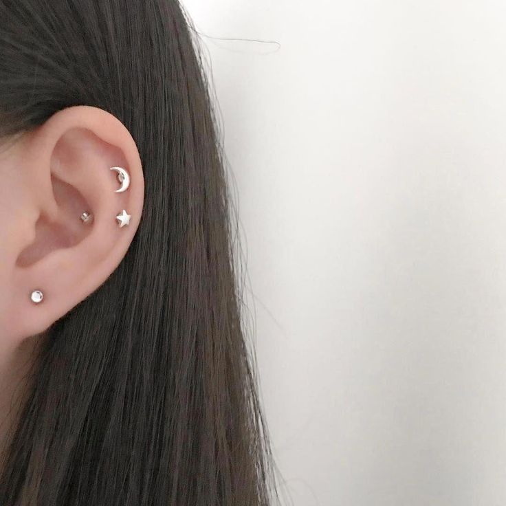 a woman's ear with two small stars on it